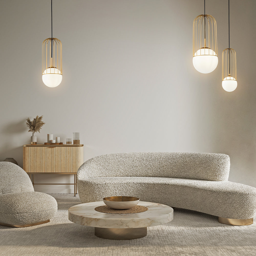 Modern living room with textured sofa, round coffee table, and pendant lights.