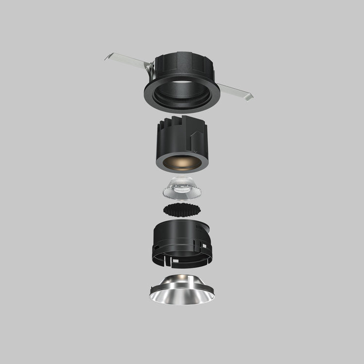 Exploded view of architectural recessed downlight components and mounting accessories