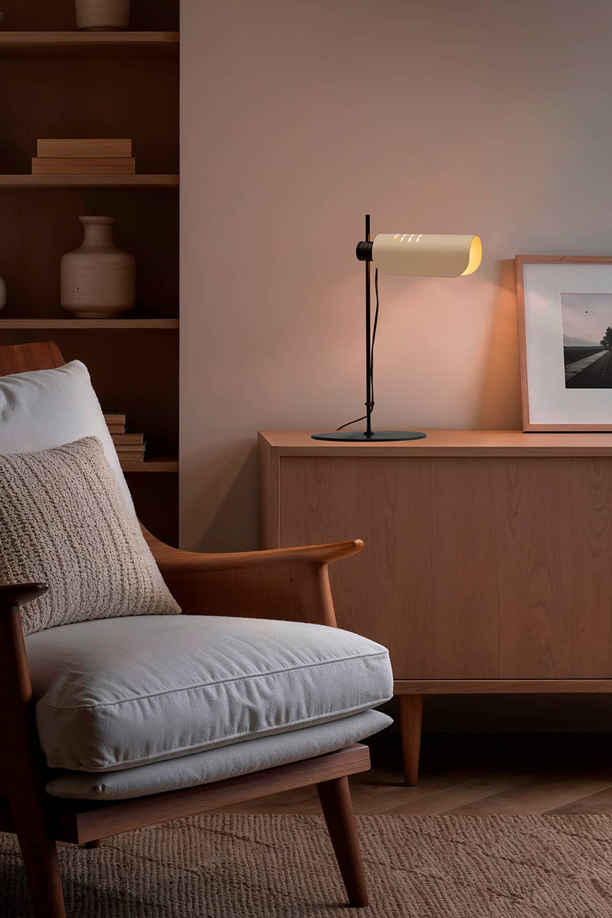 Modern interior with a wooden armchair, side table, and lamp.
