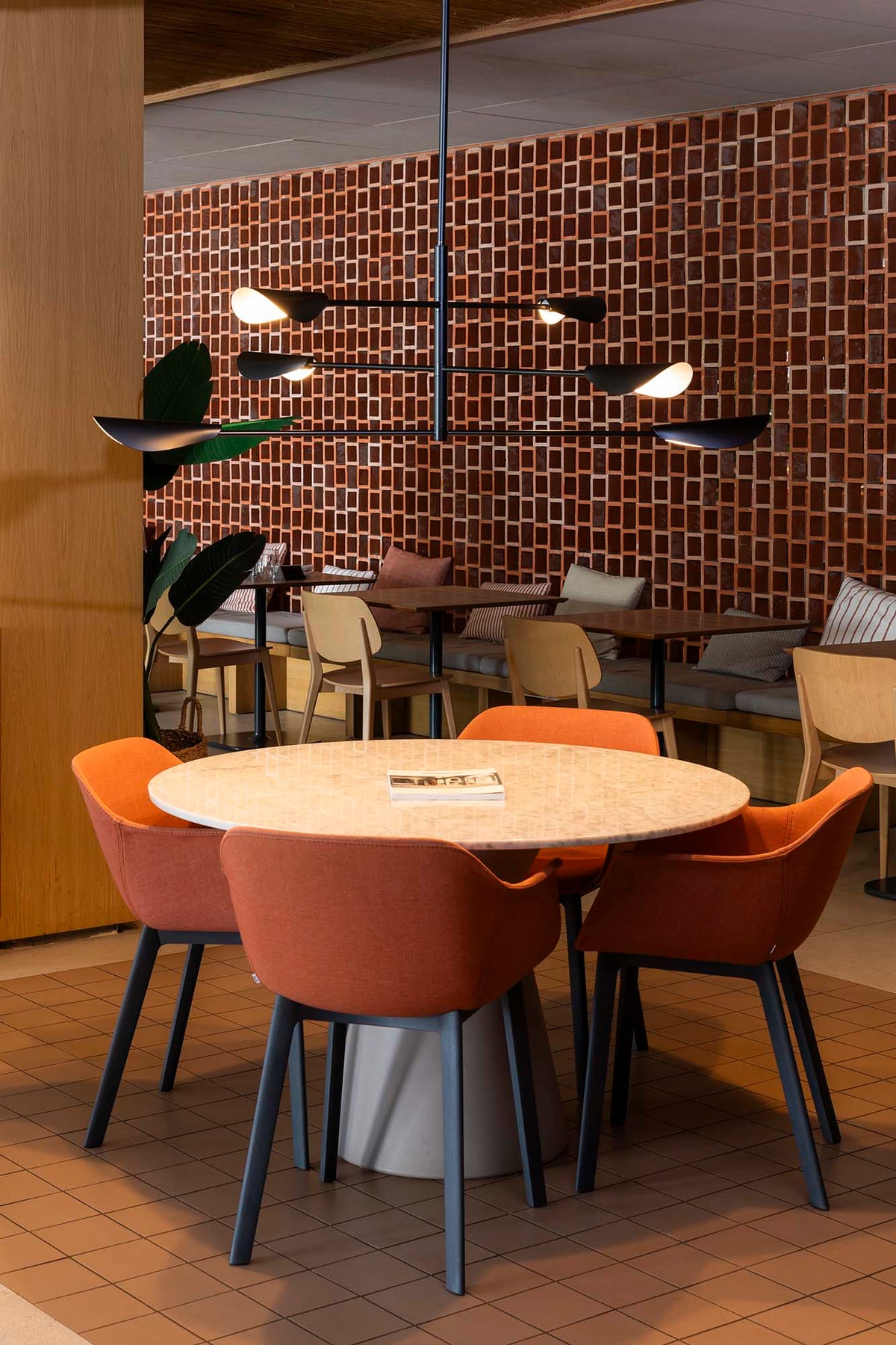Modern dining area with round table and chairs in a stylish interior setting.