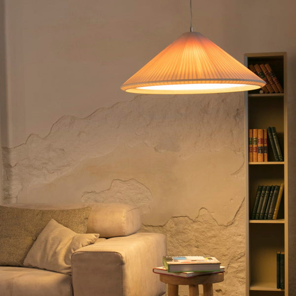 Living room with beige sofa, wooden coffee table, and bookshelf against a textured wall.