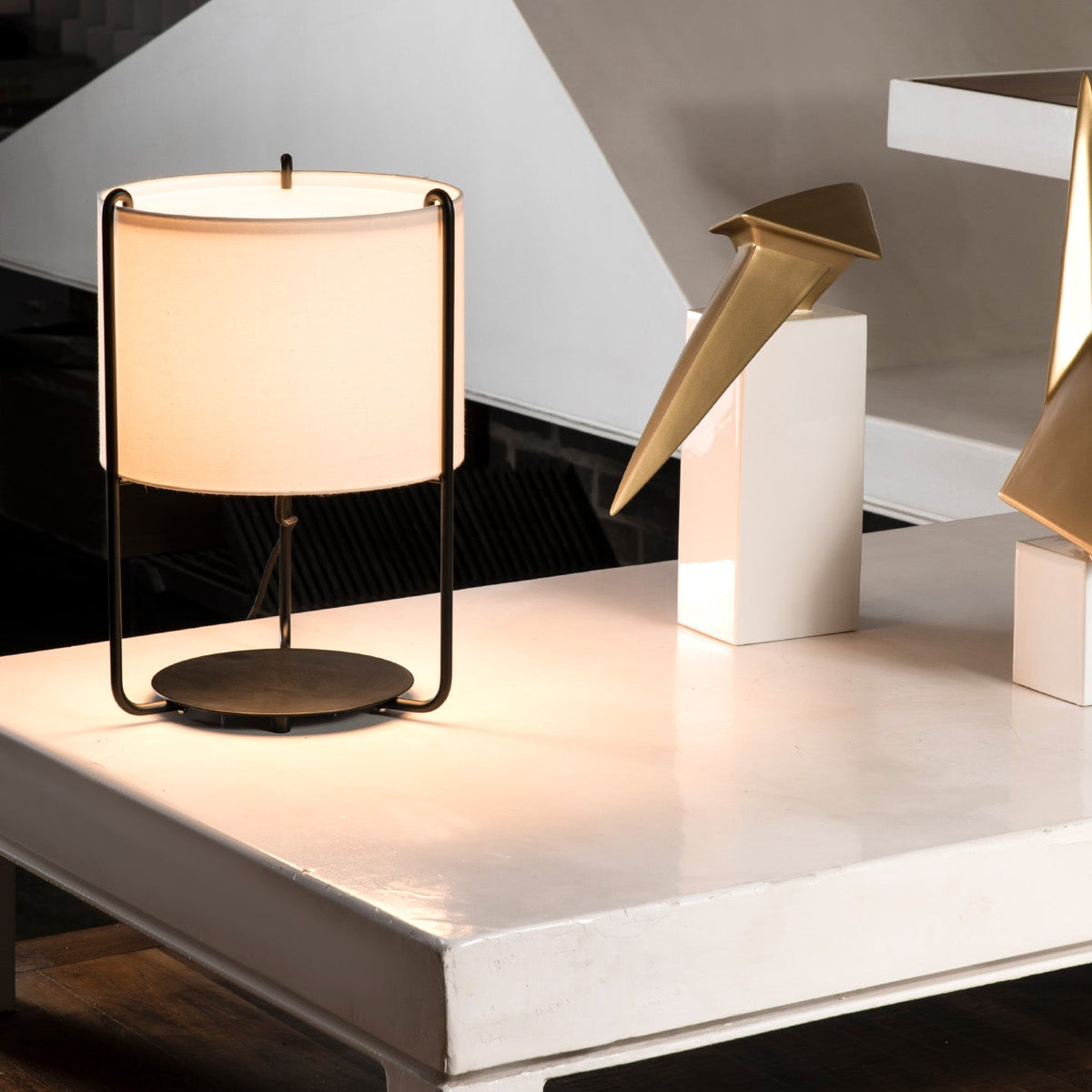 Modern table lamp on a white surface with a geometric background