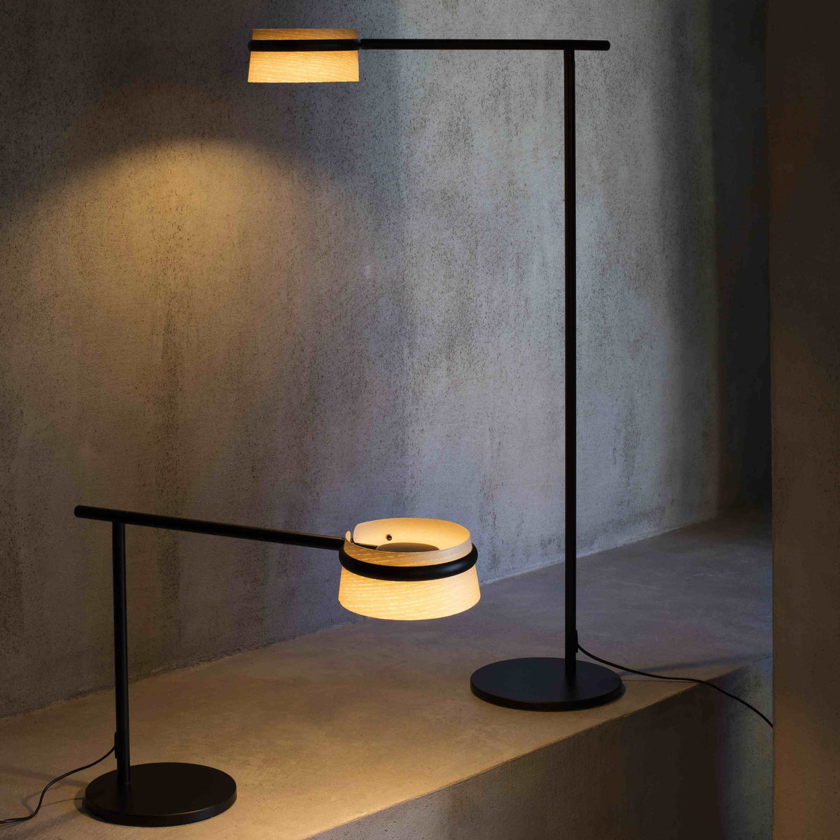 Modern floor lamp with a minimalist design on a concrete surface.