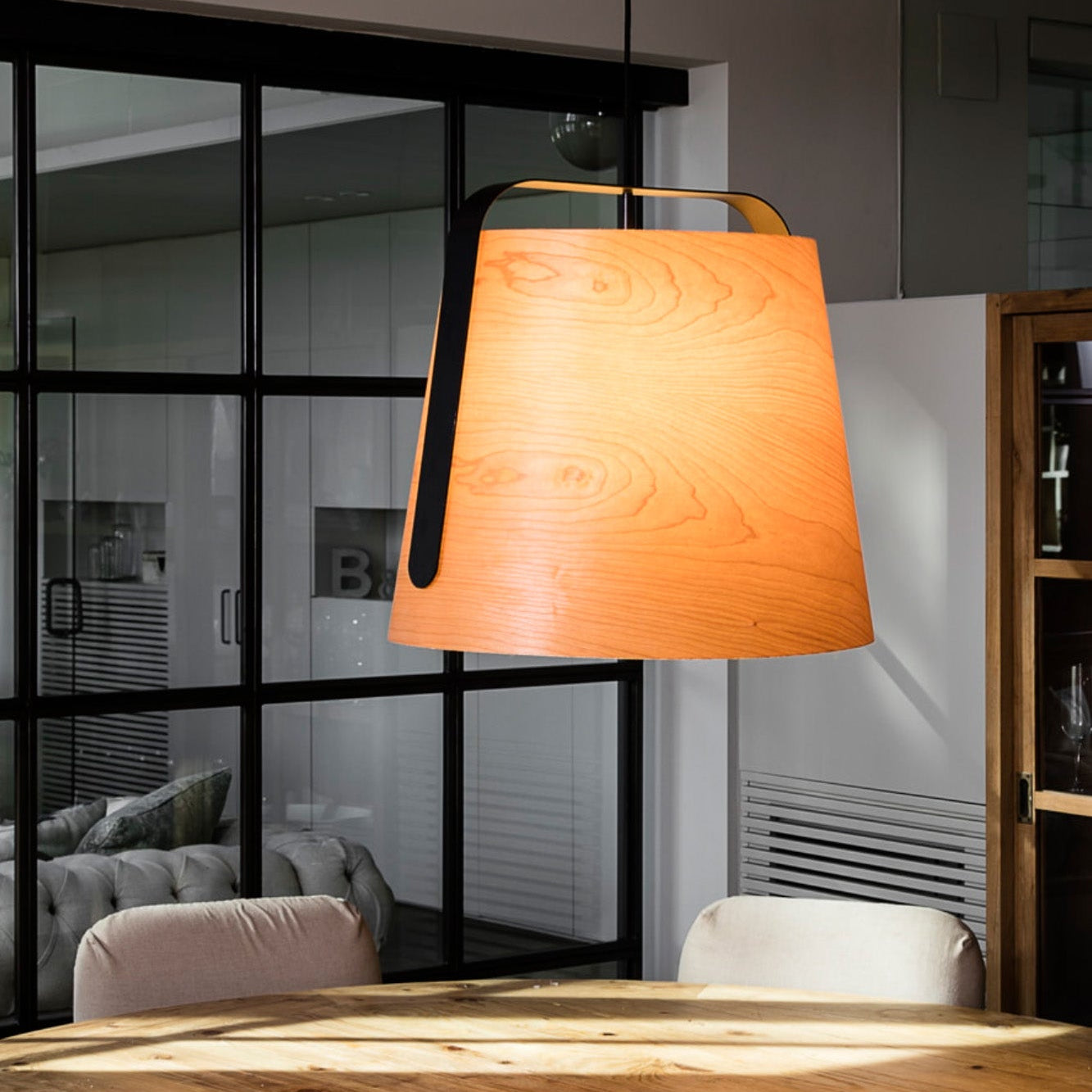 Wooden table with a pendant light in a modern interior setting