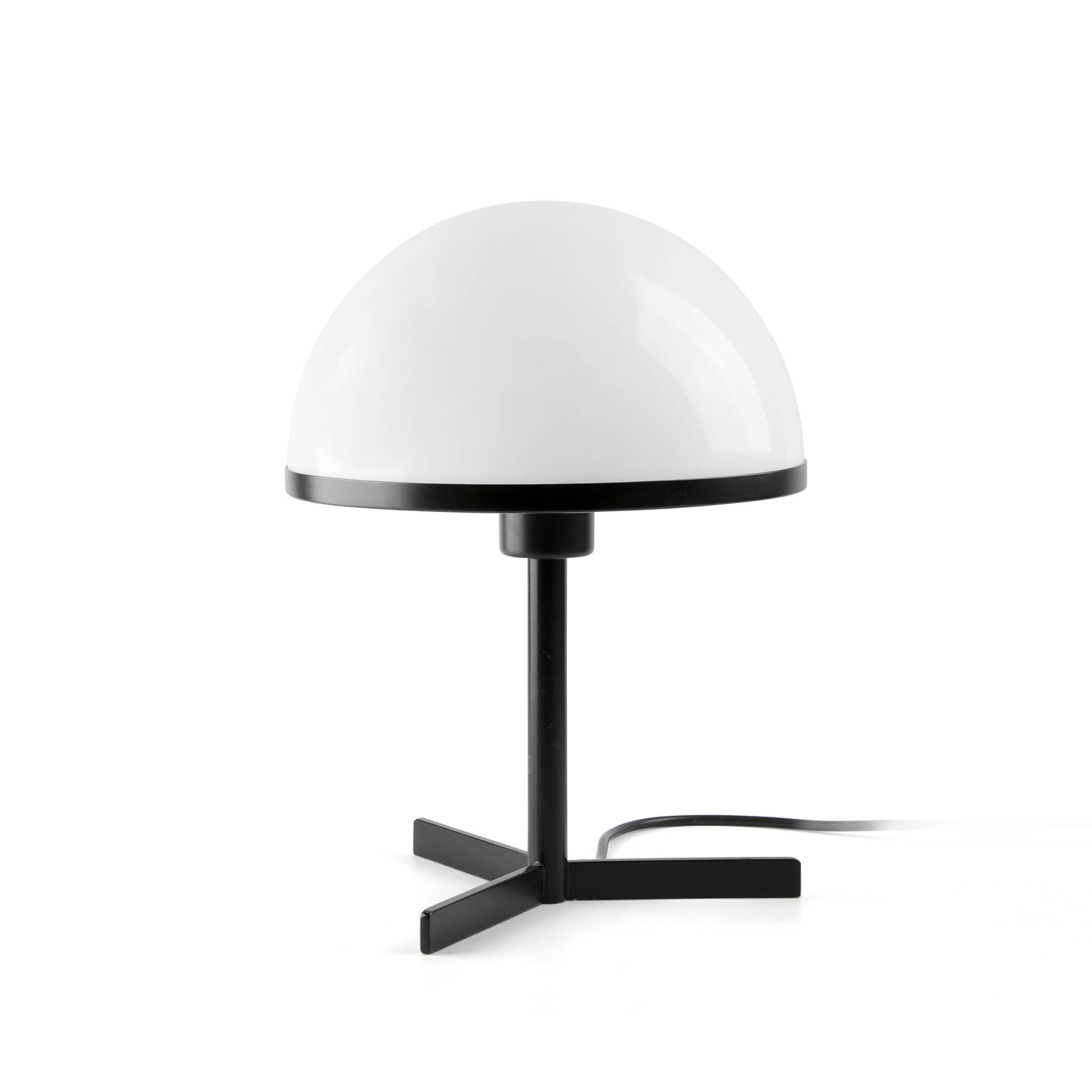 Table lamp with white dome shade and black base on a white background