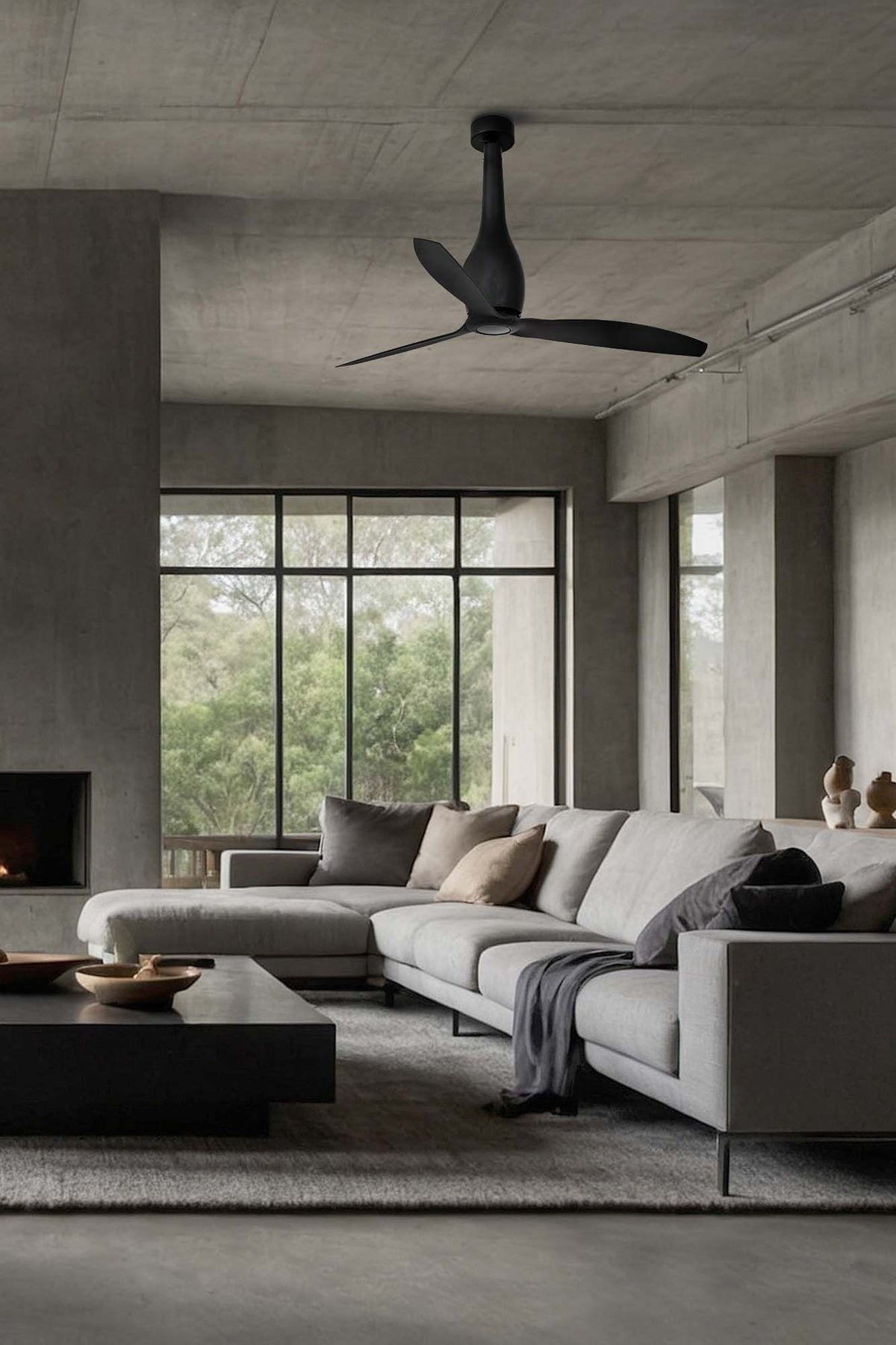 Modern living room with a sectional sofa, coffee table, and ceiling fan.