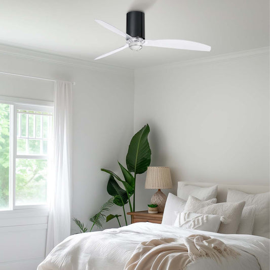 Modern bedroom with white bedding, a ceiling fan, and a plant.