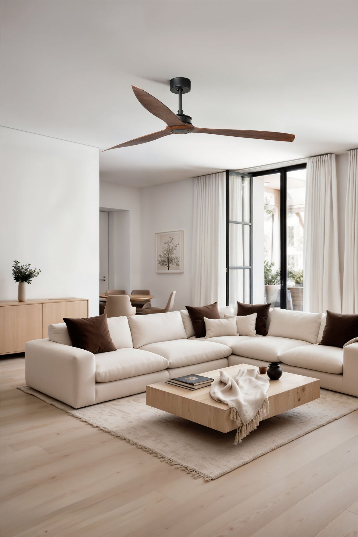 Modern living room with a sectional sofa, coffee table, and ceiling fan.