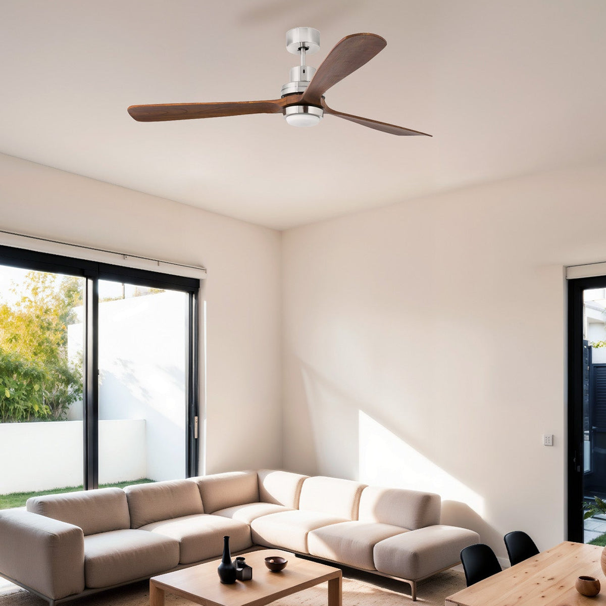 Modern living room with a ceiling fan, sofa, coffee table, and chairs.