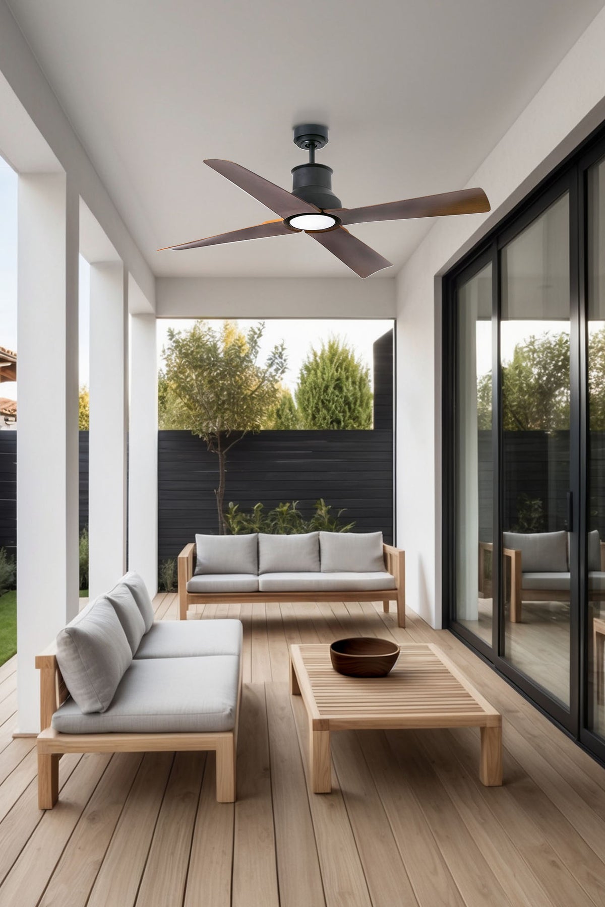 Modern outdoor patio with wooden furniture and ceiling fan