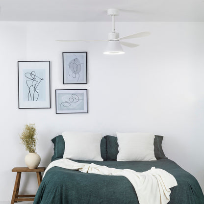 Bedroom with a bed, nightstand, and wall art on a white wall.
