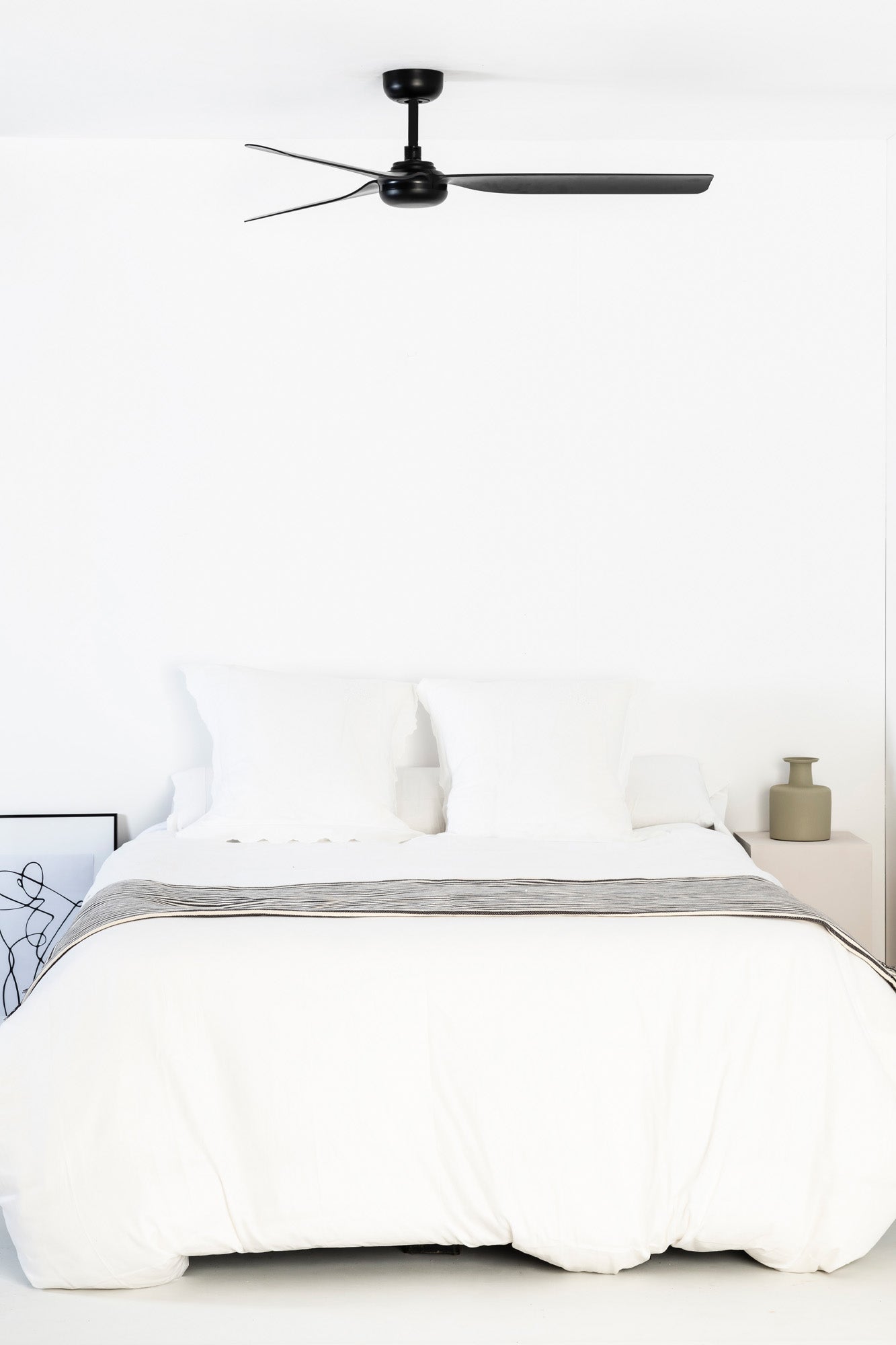 Bedroom with a bed, nightstand, and ceiling fan.