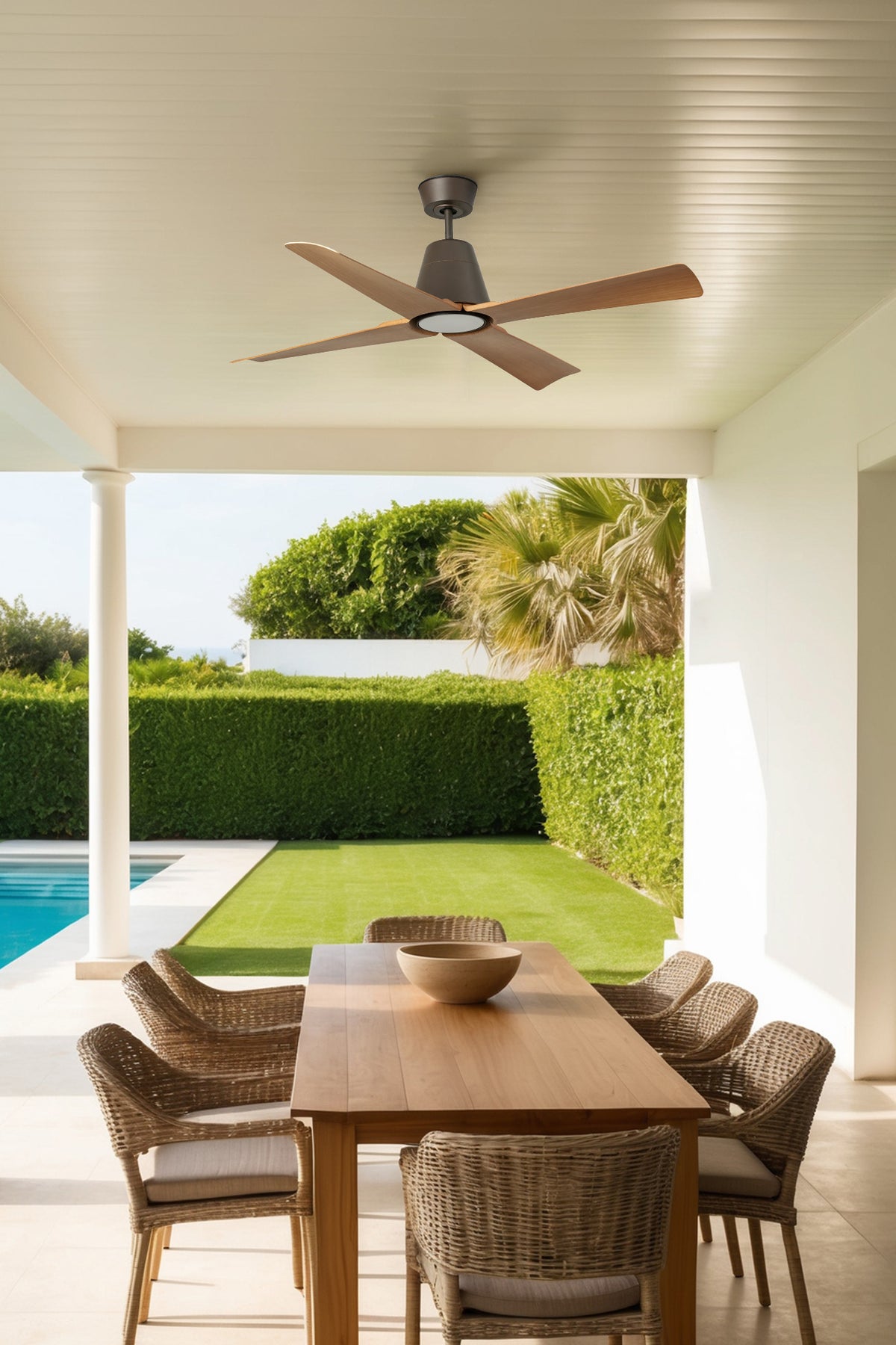 Outdoor patio with wooden table and chairs, ceiling fan, and pool view.