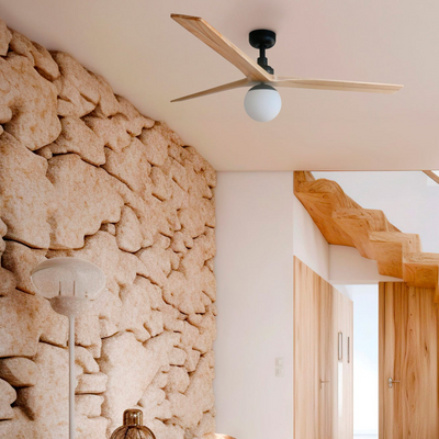 Modern interior with stone wall, wooden shelf, and ceiling fan.