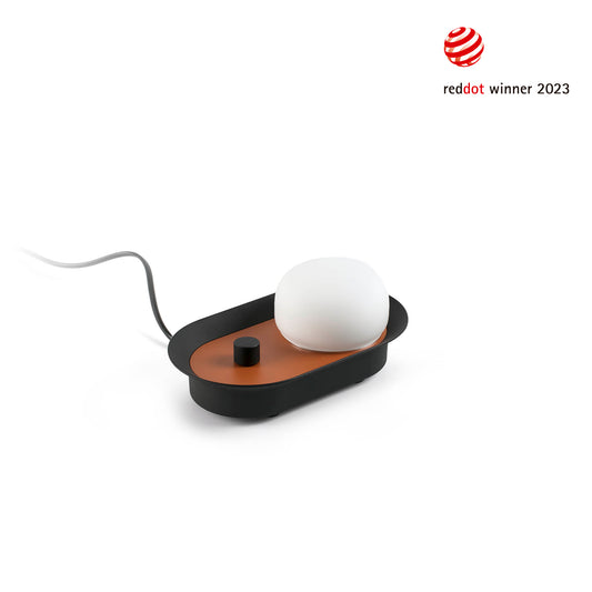 Modern table lamp and wall lamp with white bulb on a brown base, featuring Red Dot Award logo.