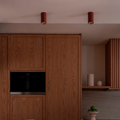 Modern kitchen with wooden cabinets and a marble countertop.