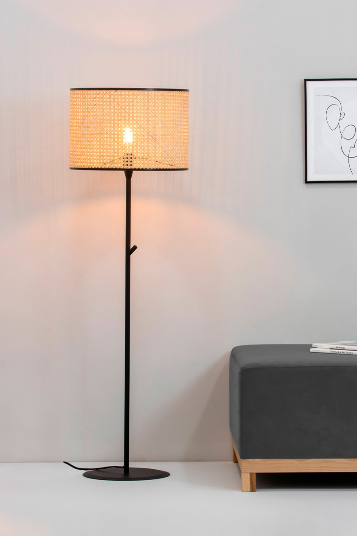 Floor lamp with a woven shade in a room setting