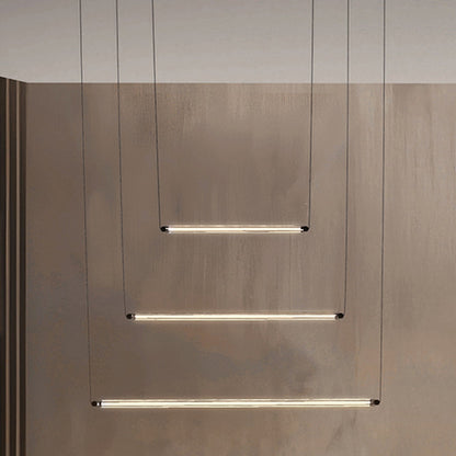 Modern interior design with hanging linear lights and a textured floor.