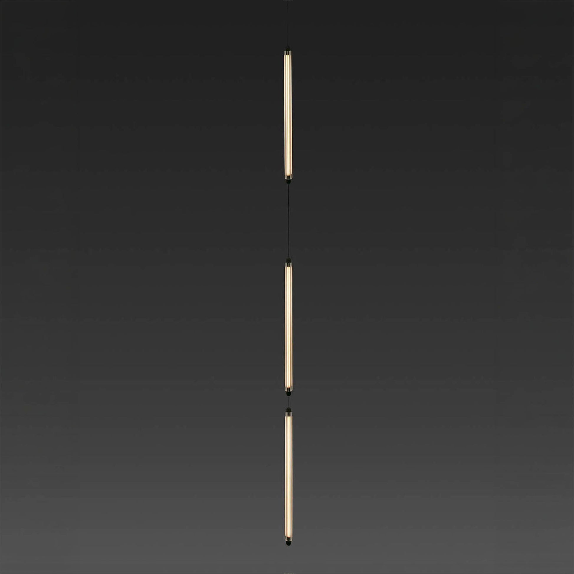 Two vertical light fixtures on a dark background