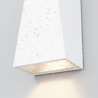 Modern wall-mounted light fixture with textured white surface on a gray background