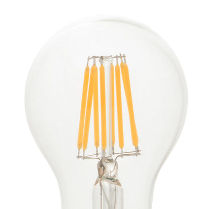 Clear light bulb with yellow filaments on a white background