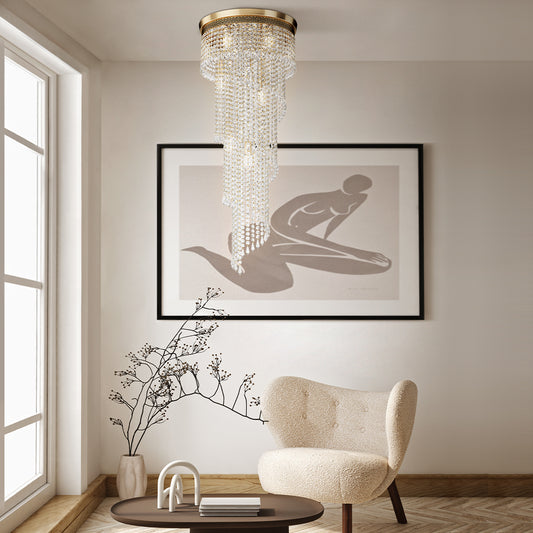 Modern interior with a chandelier, armchair, and framed artwork on a wall.