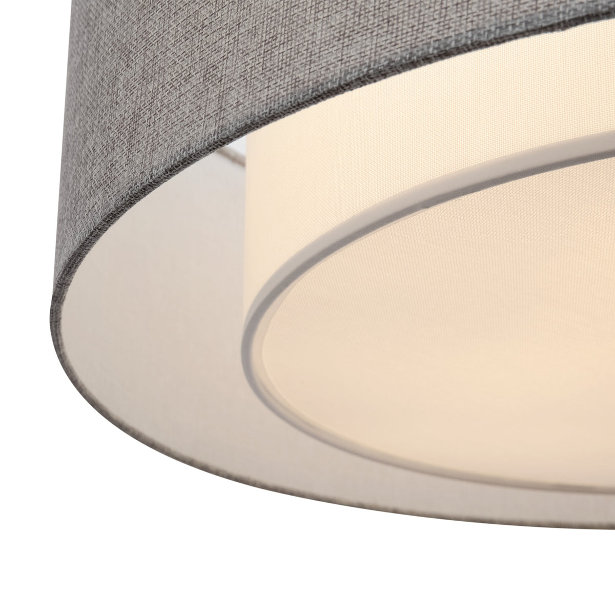 Close-up of a lampshade with gray top and beige bottom on a white background