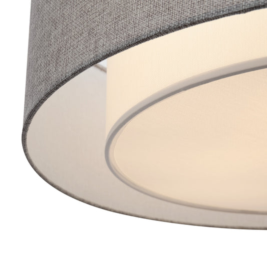 Close-up of a lampshade with gray top and beige bottom on a white background