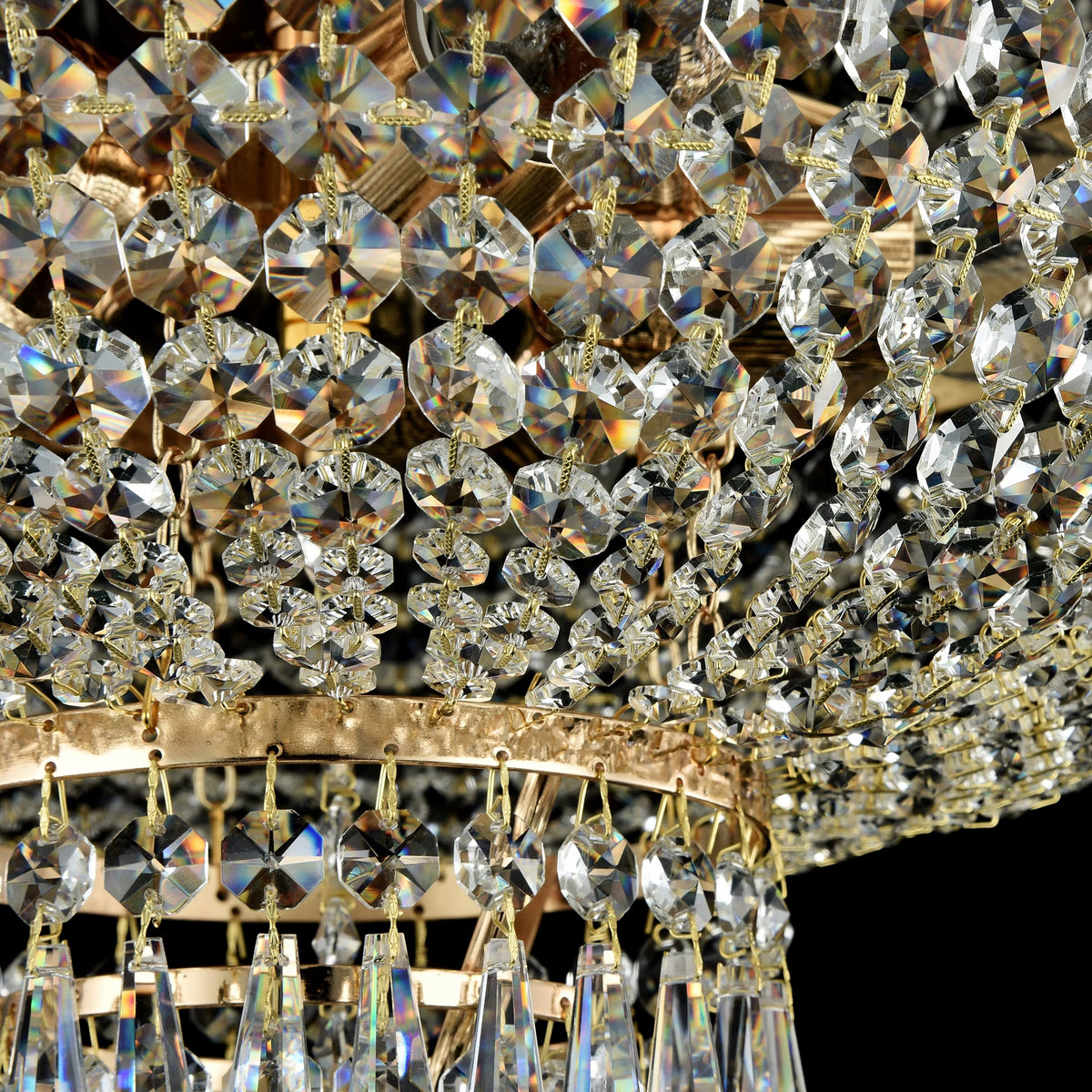 Close-up of a crystal chandelier with gold accents