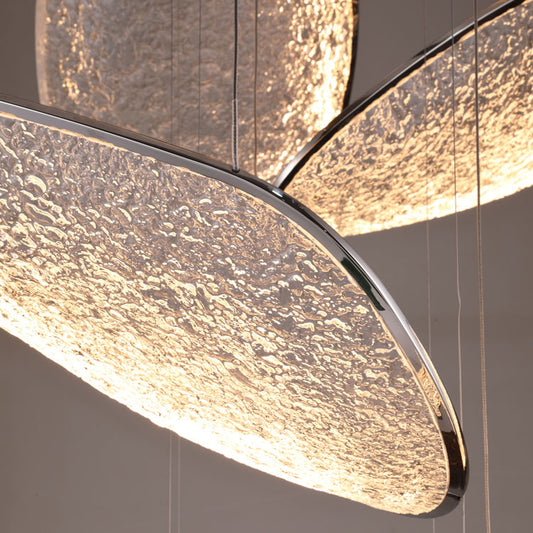 Close-up macro detail of the Empire modern LED chandelier showing the textured crystalline acrylic diffuser discs and polished chrome edge trim. Available to buy at the VXR Space store