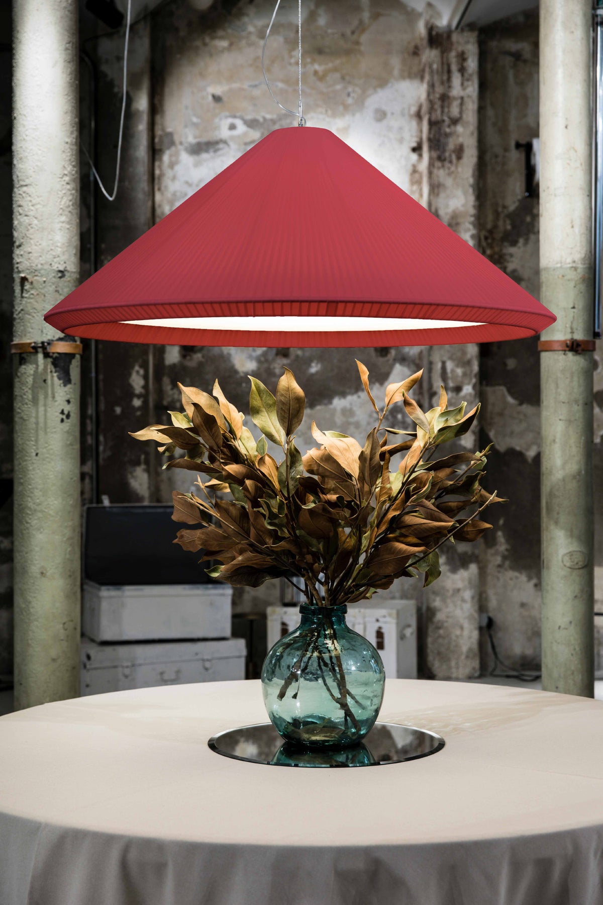 The Saigon-In 1300 garnet pendant light by Faro Barcelona suspended in a rustic-industrial interior above a table with a decorative vase. Showcases the fixture's monumental presence, available at the VXR Space store.