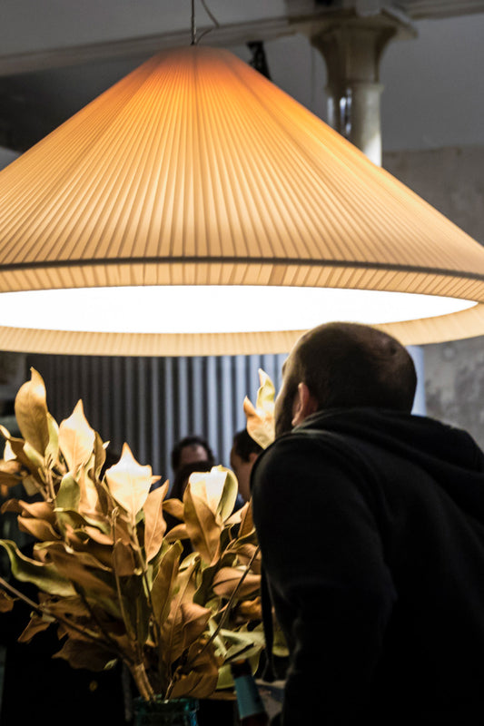 The Saigon-In 1300 ivory white pendant light by Faro Barcelona illuminating an interior space with warm diffused light, demonstrating its monumental scale. Available at the VXR Space store.