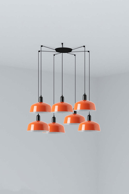 The Faro Barcelona Tatawin 7-light pendant lamp featuring a cluster of gloss reddish-orange steel shades suspended from a minimalist black structure. Featured in the VXR Space lighting collection.