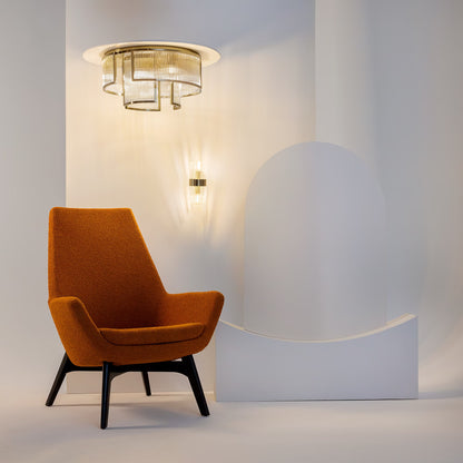 Modern interior scene featuring the 9-light Frame gold ribbed glass flush mount ceiling luminaire casting ambient light over a cozy seating area. Featured in the VXR Space lighting collection.