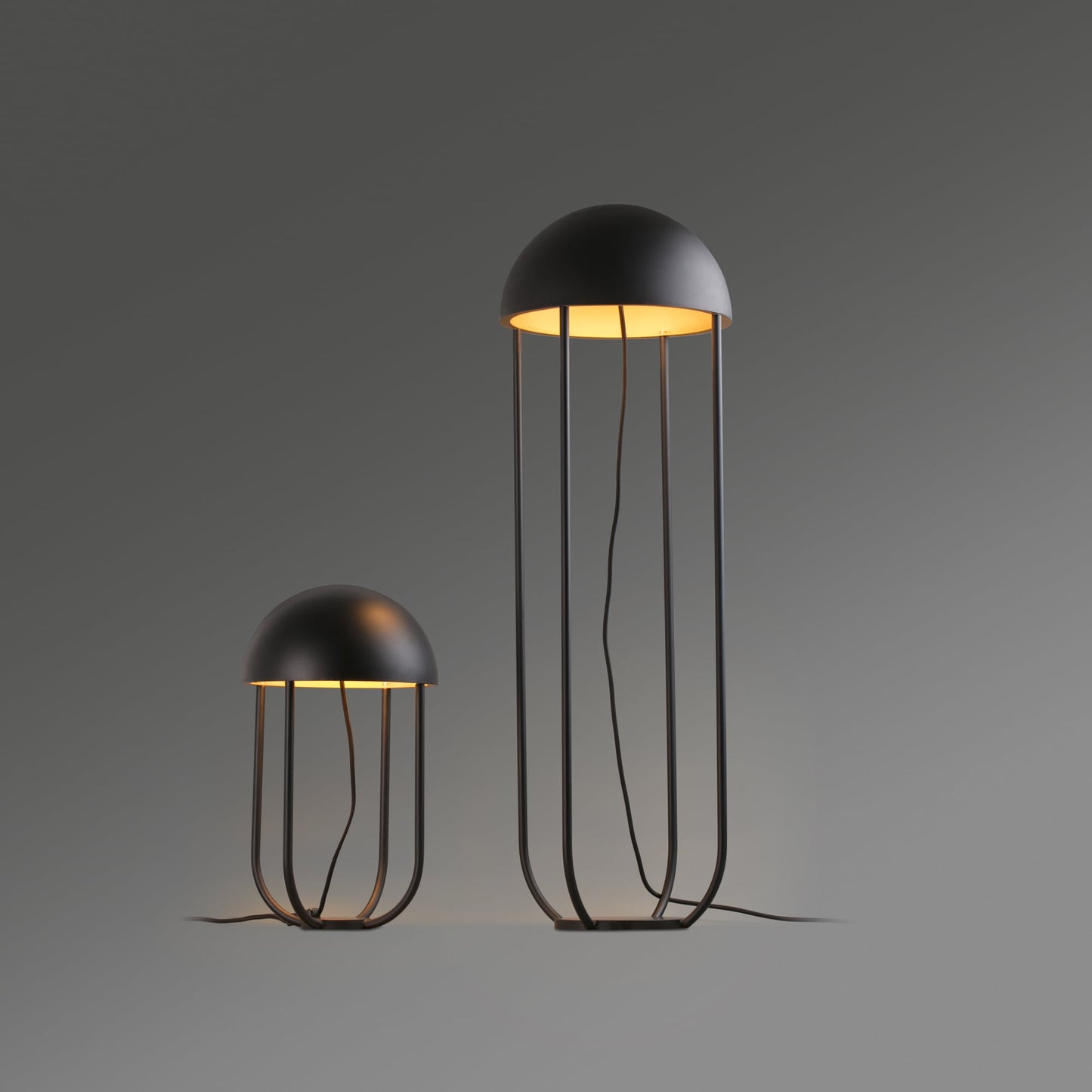 Two modern jellyfish-shaped lamps on a gray background