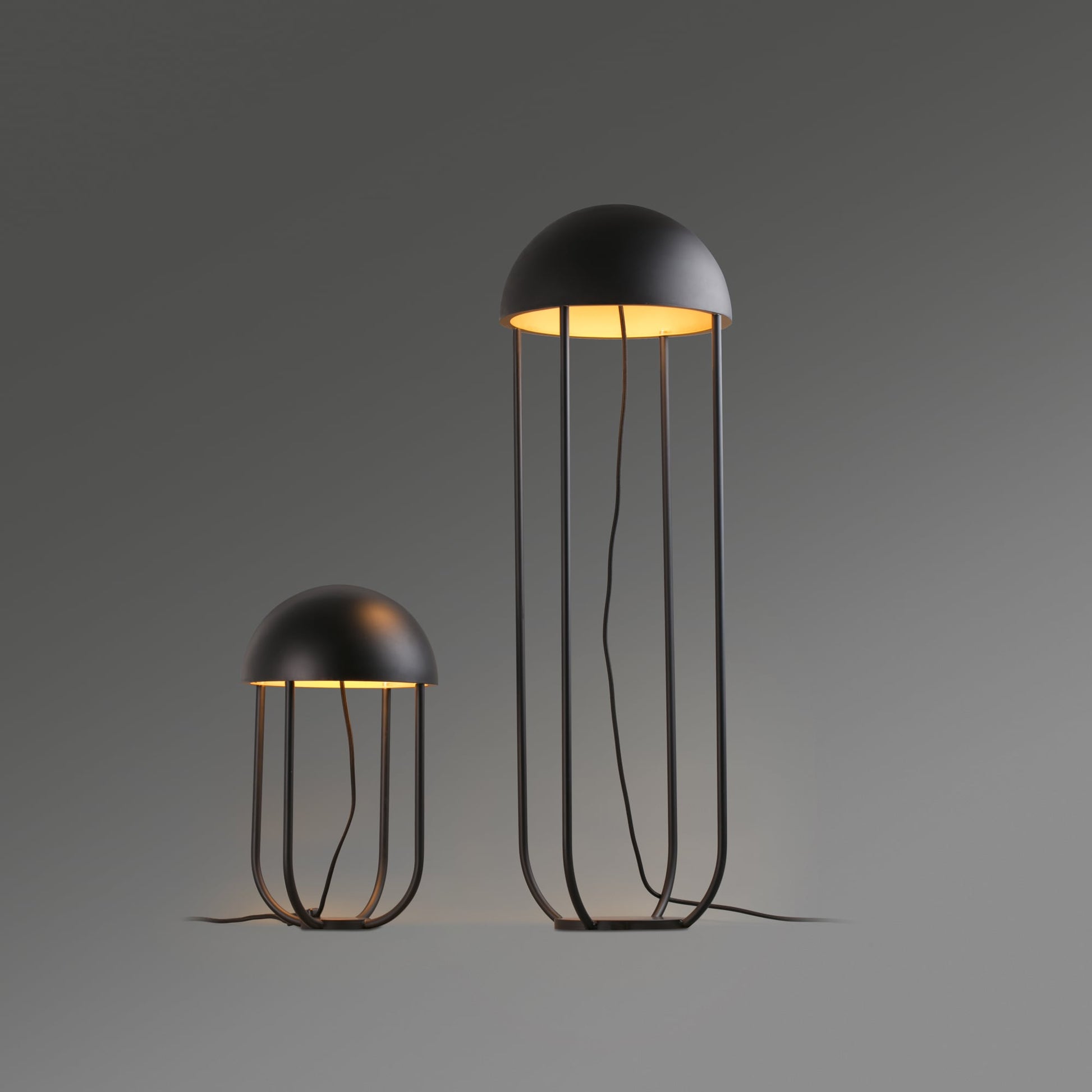 Two modern jellyfish-shaped lamps on a gray background