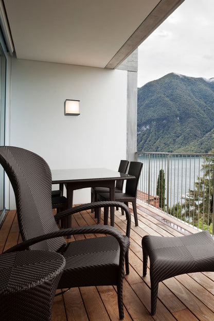Contemporary style outdoor wall lamp made of injected aluminum and opal PVC diffuser.