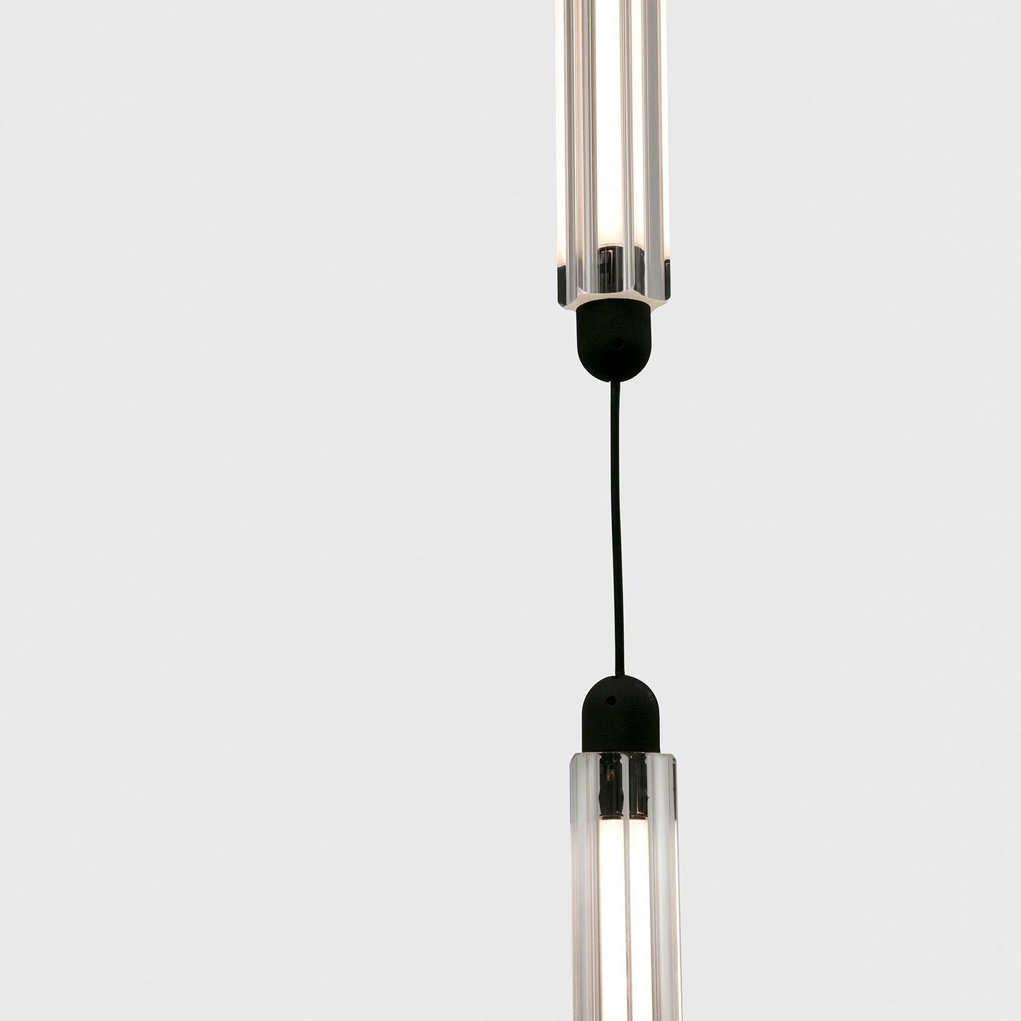 Modern pendant light with clear cylindrical design on a white background