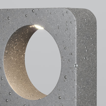 Concrete block with a circular cutout on a gray background