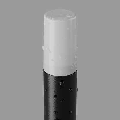 A close-up of a cylindrical cosmetic bottle or tube with a white cap covered in water droplets and a black textured lower body, shown against a plain gray background.