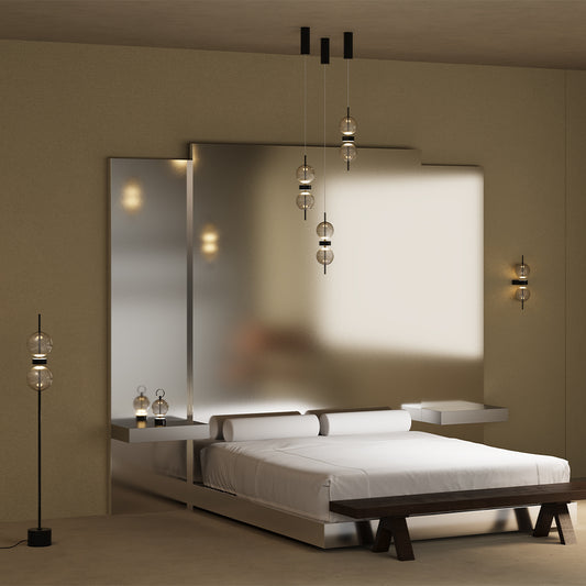 Modern bedroom with a large mirror, bed, and decorative pendant lamp and table lights.