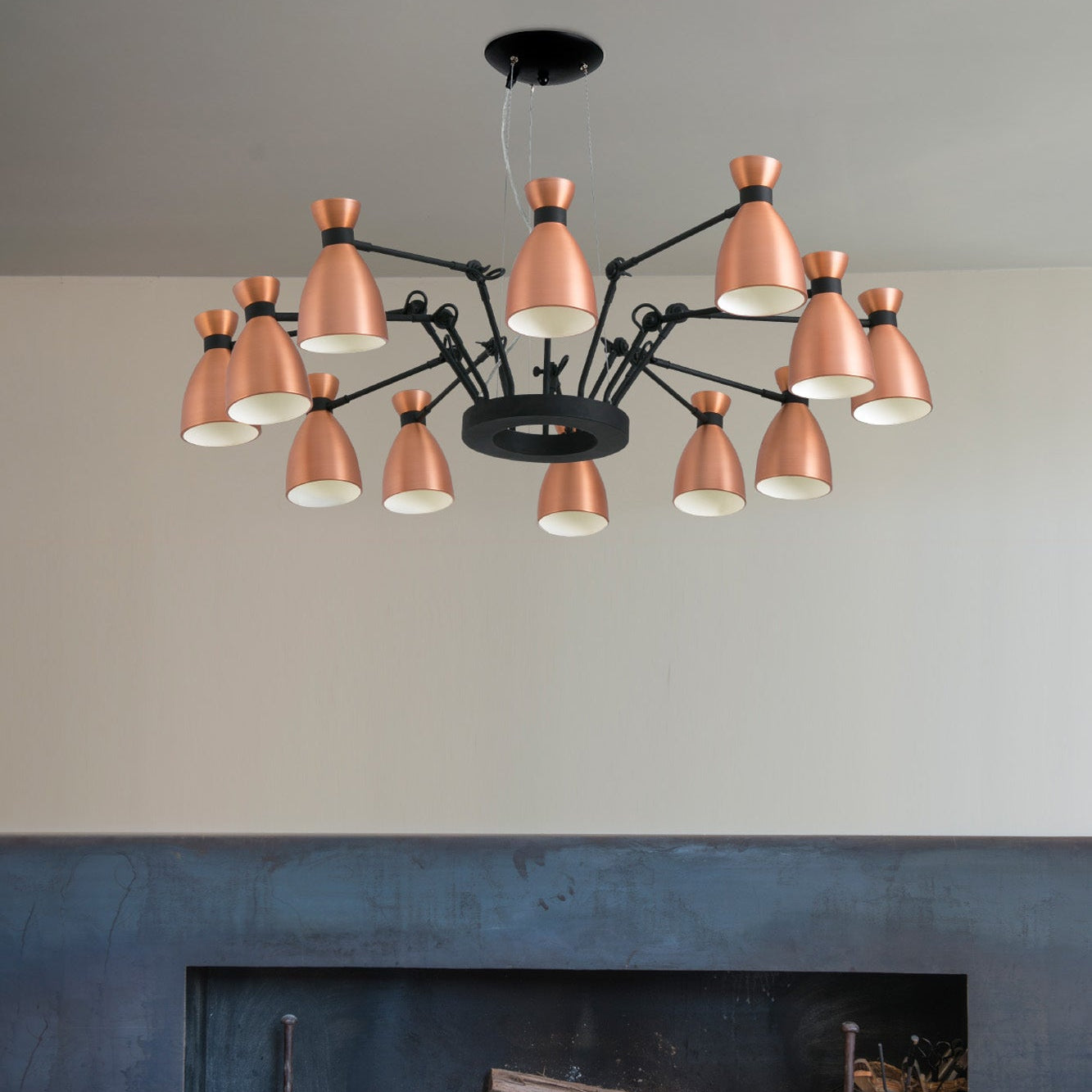 Modern chandelier with copper-colored lights in a living room setting.