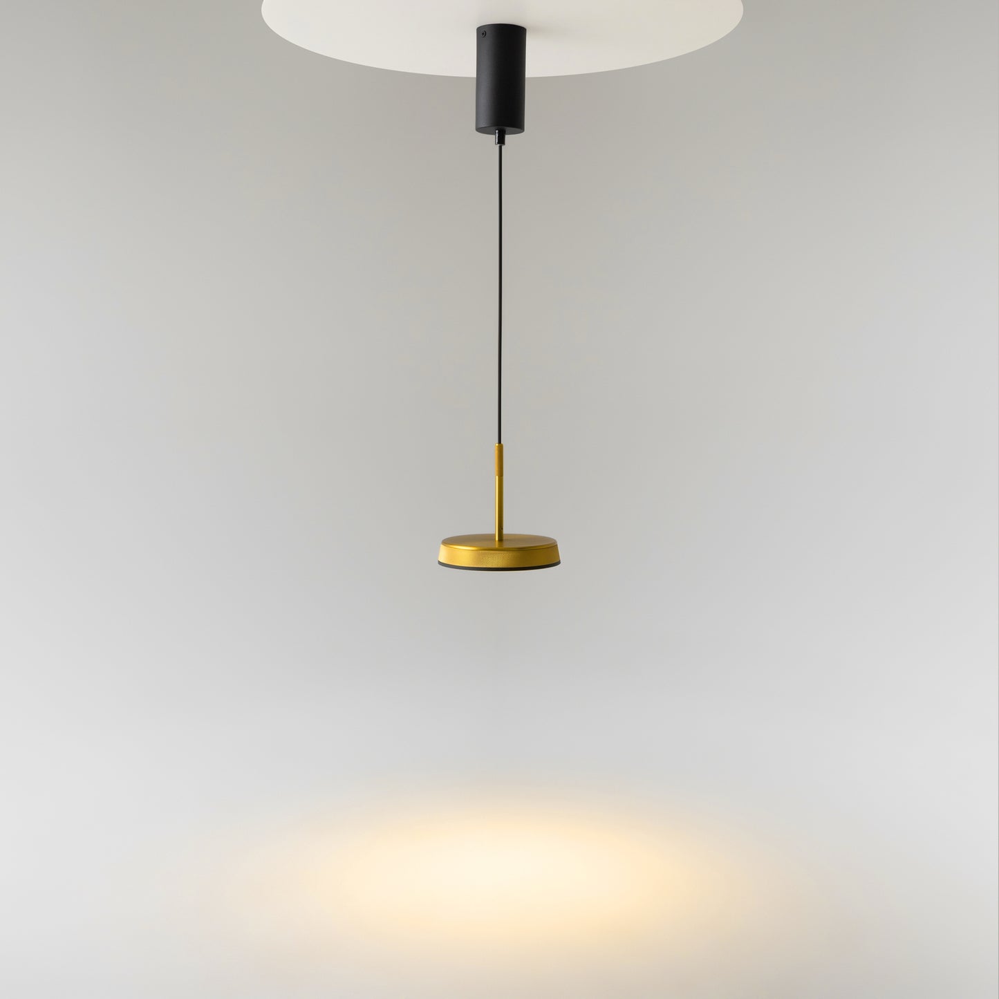 Modern pendant light Maytoni with gold base and black cable on a gray background
