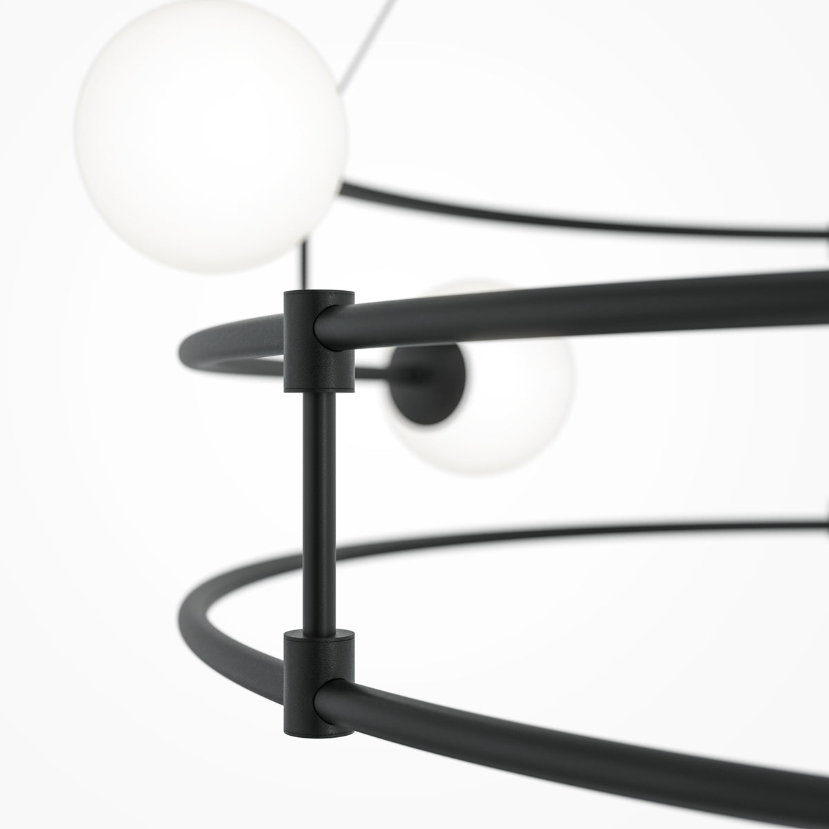 Close-up of a modern black pendant light fixture with spherical glass shades on a white background.