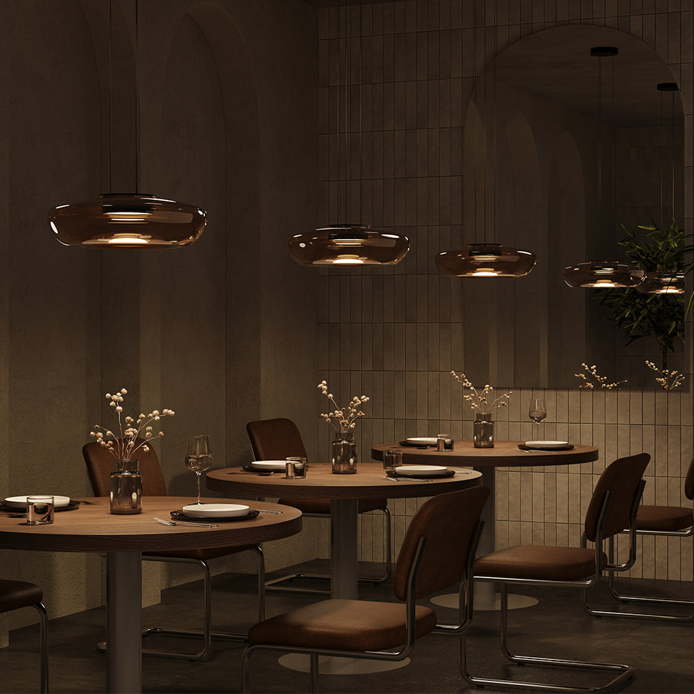 Dining area with round tables, chairs, and decorative elements in a dimly lit room.