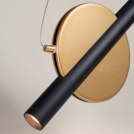 Modern wall light fixture with black and gold design on a neutral background