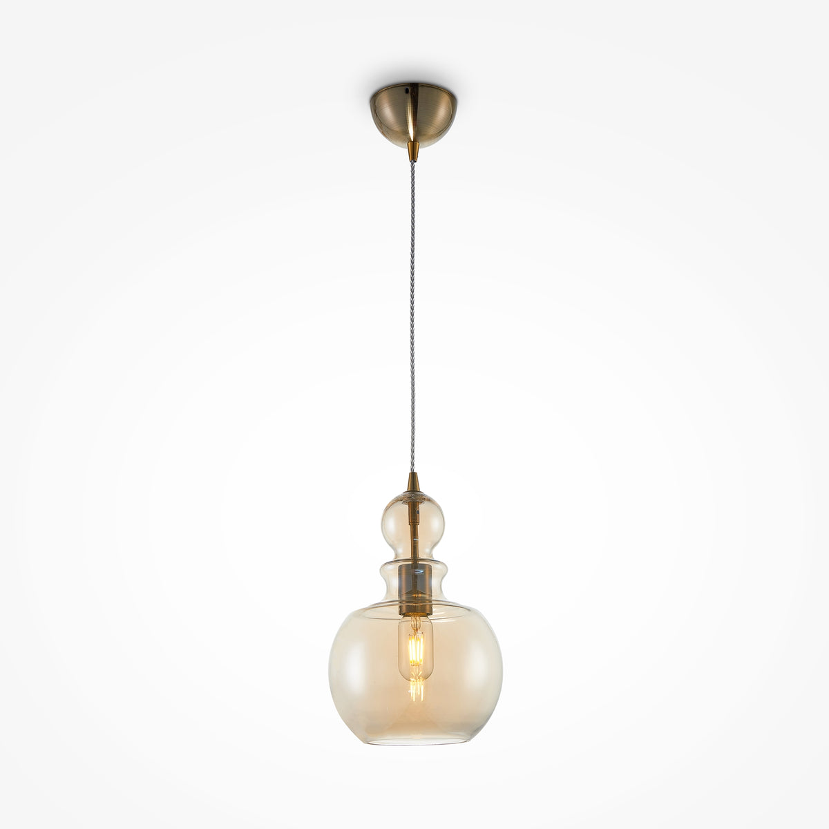Pendant light with glass shade and brass fixture on a white background