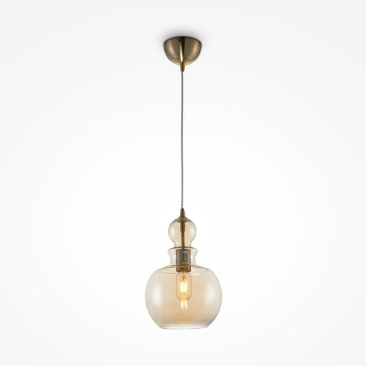 Pendant light with glass shade and brass fixture on a white background