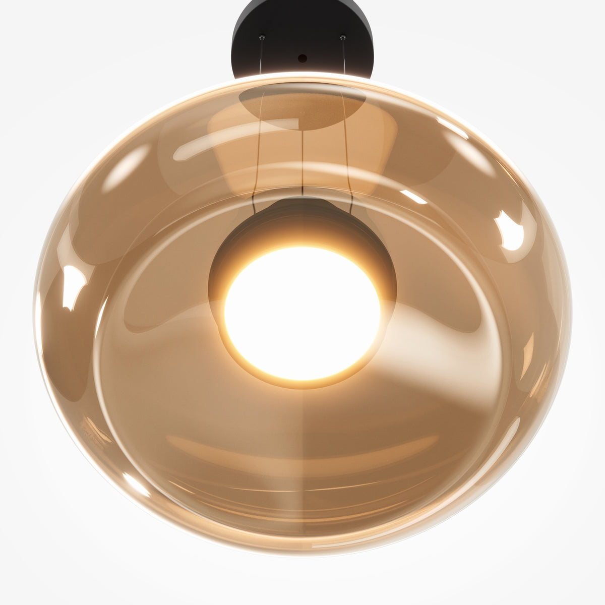 A modern pendant light with a large, glossy, warm-tinted amber glass shade and a central glowing bulb, suspended from a black ceiling mount against a white background.