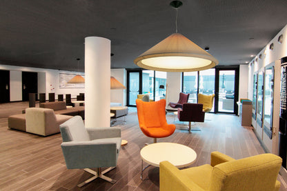 Modern office lobby with colorful chairs and a large window view.
